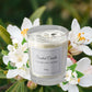 A single lit candle on a bedside table, illustrating the warm ambiance and 8-hour burn time